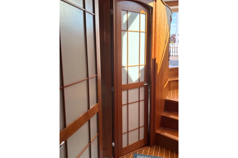  Yacht Photos Pics Interior of 2023 Sabre 45 Salon Express with elegant wooden door and stairs.