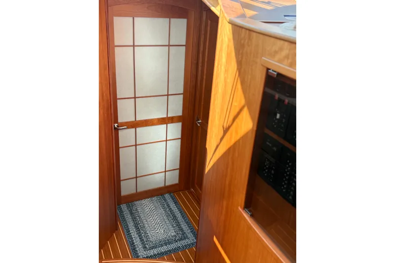  Yacht Photos Pics Interior of 2023 Sabre 45 Salon Express with wooden door and nautical decor.