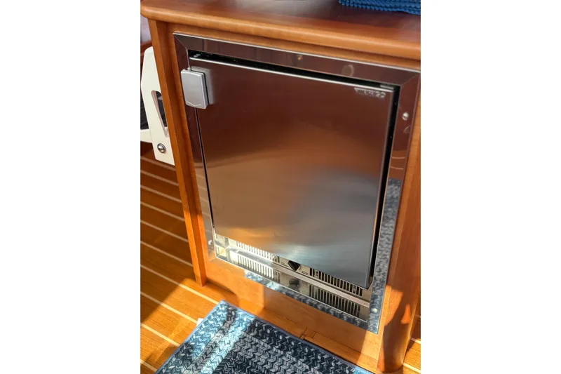  Yacht Photos Pics Stainless steel fridge on 2023 Sabre 45 Salon Express yacht, wooden interior.