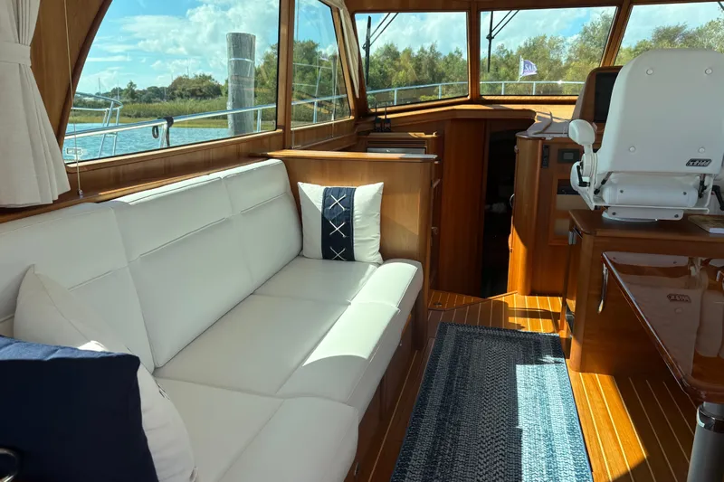  Yacht Photos Pics Interior of 2023 Sabre 45 Salon Express yacht with white seating and wooden accents.