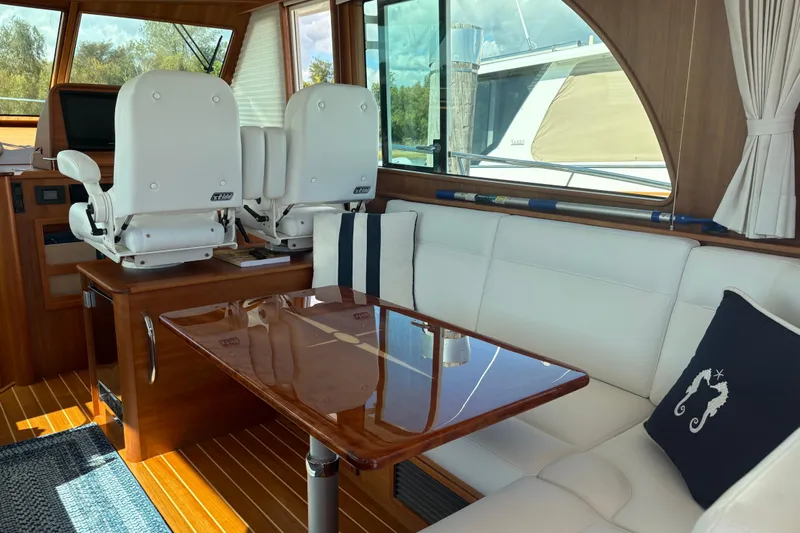  Yacht Photos Pics Interior of 2023 Sabre 45 Salon Express with elegant seating and wooden table.