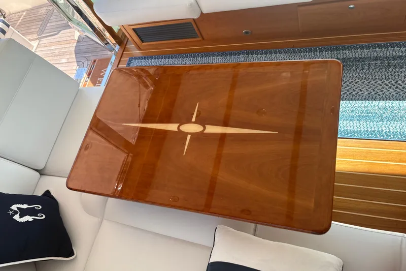  Yacht Photos Pics Luxurious wooden table on 2023 Sabre 45 Salon Express yacht interior.