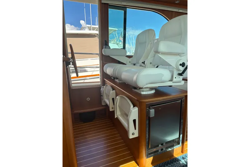  Yacht Photos Pics Interior of 2023 Sabre 45 Salon Express with white captain's chairs and wooden flooring.