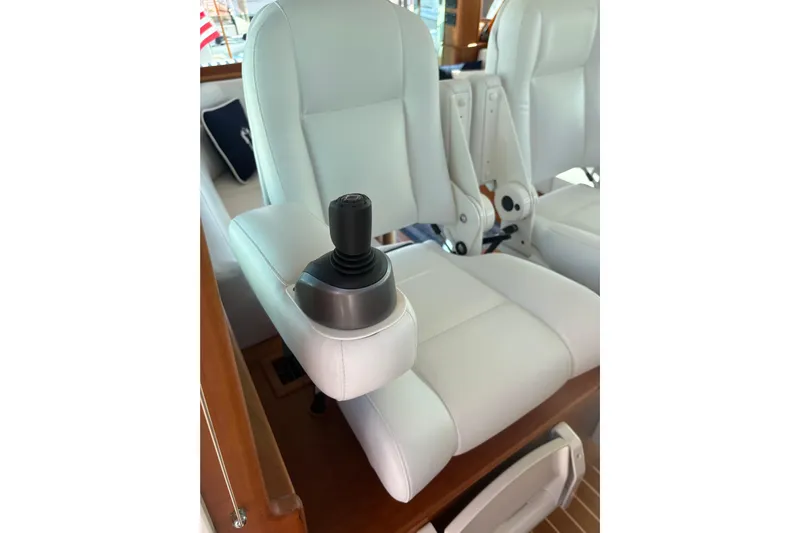  Yacht Photos Pics 2023 Sabre 45 Salon Express interior with white leather seating and joystick control.