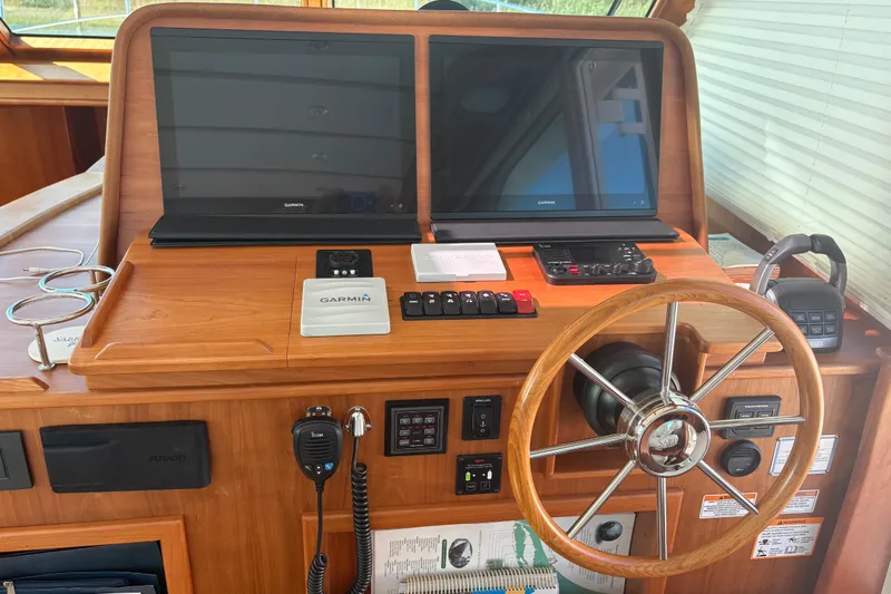  Yacht Photos Pics Helm of 2023 Sabre 45 Salon Express with dual Garmin displays and wooden steering wheel.