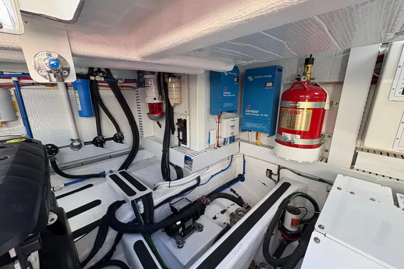  Yacht Photos Pics Engine room of 2023 Sabre 45 Salon Express with fire extinguisher and battery chargers.