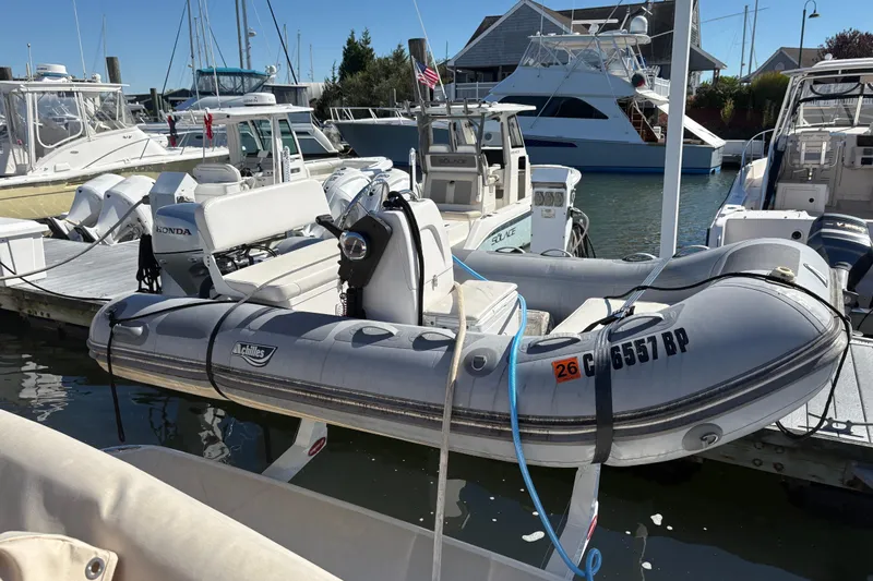  Yacht Photos Pics Docked inflatable boat near Sabre 45 Salon Express, 2023 model, in a marina setting.