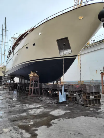 Korab Yacht Photos Pics Motor Yacht Korab 2001 on dry dock for maintenance, showcasing its hull and anchor.