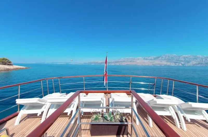 Korab Yacht Photos Pics Luxurious deck of Motor Yacht Korab, 2001, with sun loungers and stunning ocean view.