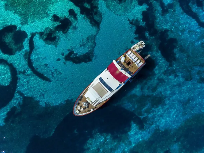 Korab Yacht Photos Pics Aerial view of Motor Yacht Korab, 2001, cruising in clear blue waters.