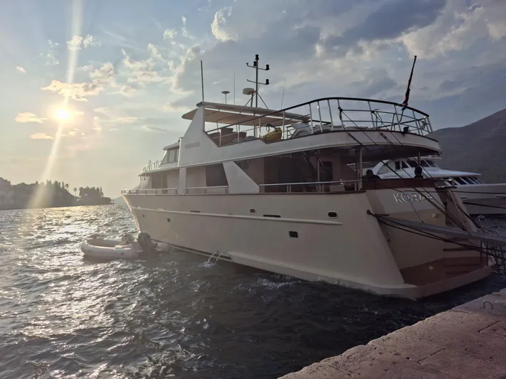 Korab Yacht Photos Pics Custom Motor Yacht Korab, 2001, docked at sunset with scenic ocean view.