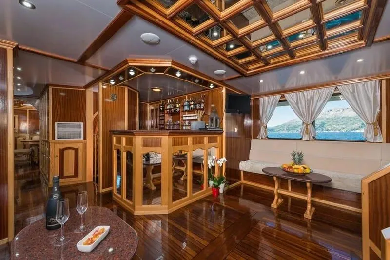 Korab Yacht Photos Pics Luxurious interior of 2001 Custom Motor Yacht Korab with elegant wood finishes and bar area.