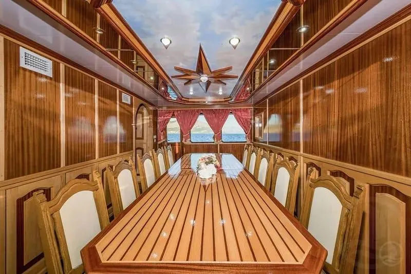Korab Yacht Photos Pics Luxurious dining room on 2001 Custom Motor Yacht Korab with elegant wood paneling and long table.