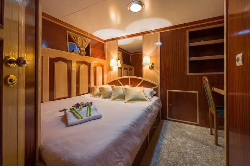 Korab Yacht Photos Pics Luxurious cabin interior of 2001 Custom Motor Yacht Korab with cozy bed and elegant decor.