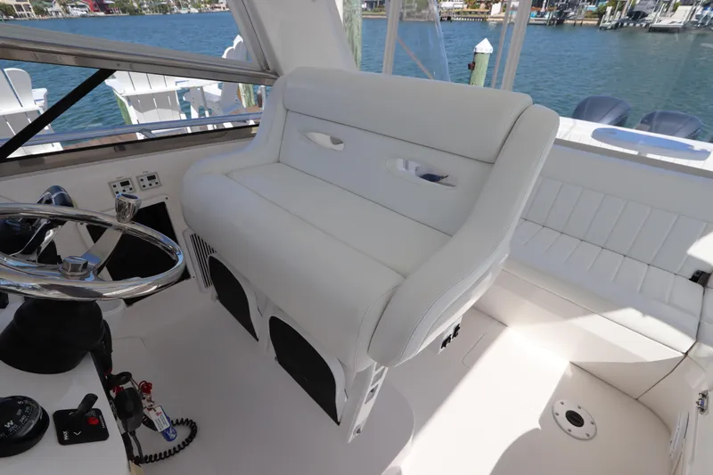 Relentless Yacht Photos Pics Luxury helm seating on 2012 Intrepid 430 Sport Yacht with waterfront view.