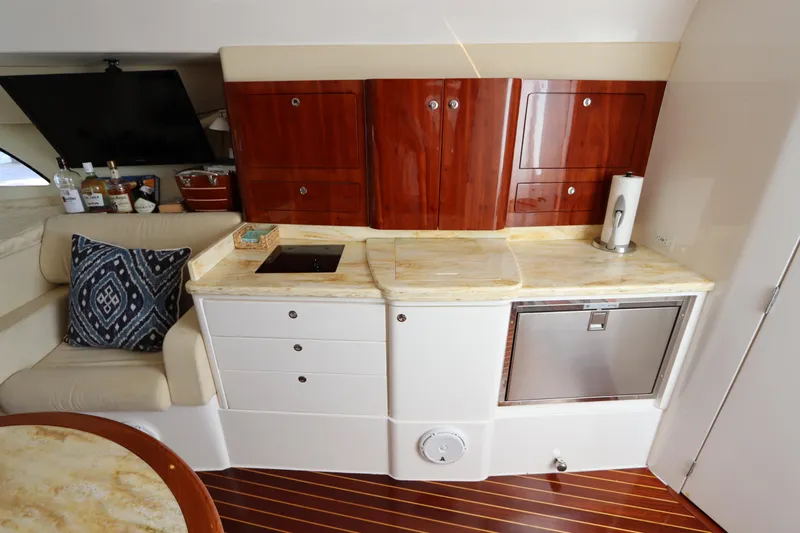 Relentless Yacht Photos Pics Luxurious 2012 Intrepid 430 Sport Yacht interior with elegant kitchenette and seating area.