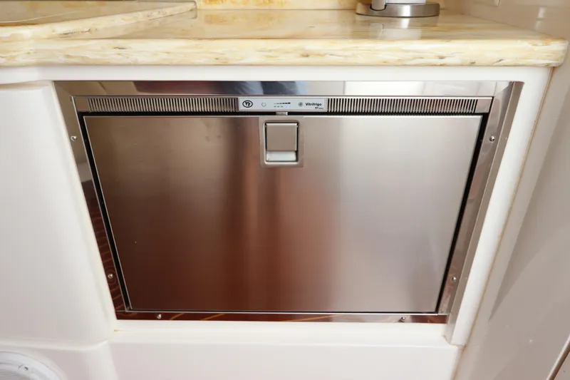 Relentless Yacht Photos Pics Stainless steel refrigerator on 2012 Intrepid 430 Sport Yacht, under marble countertop.
