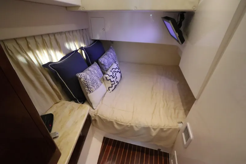 Relentless Yacht Photos Pics Cozy cabin interior of 2012 Intrepid 430 Sport Yacht with bed and pillows.