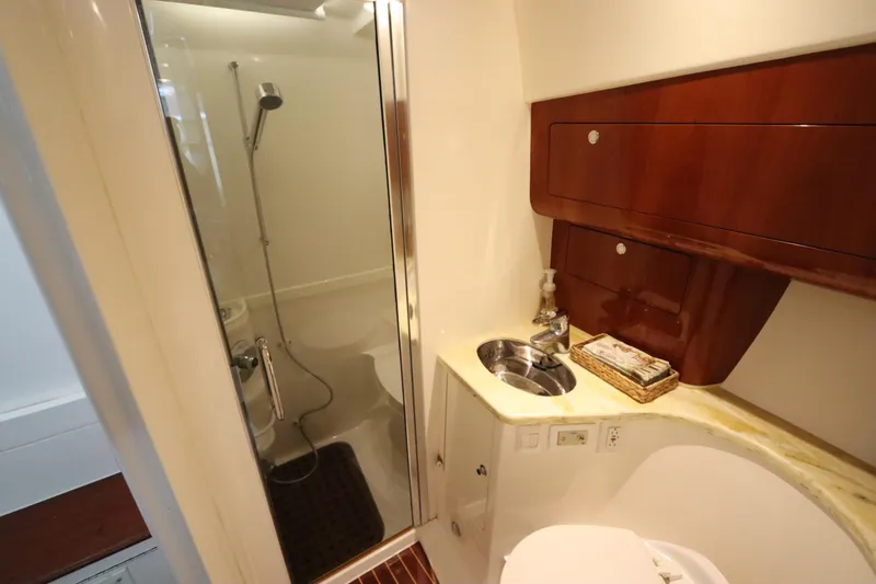 Relentless Yacht Photos Pics Luxurious bathroom in 2012 Intrepid 430 Sport Yacht with shower and wooden cabinetry.