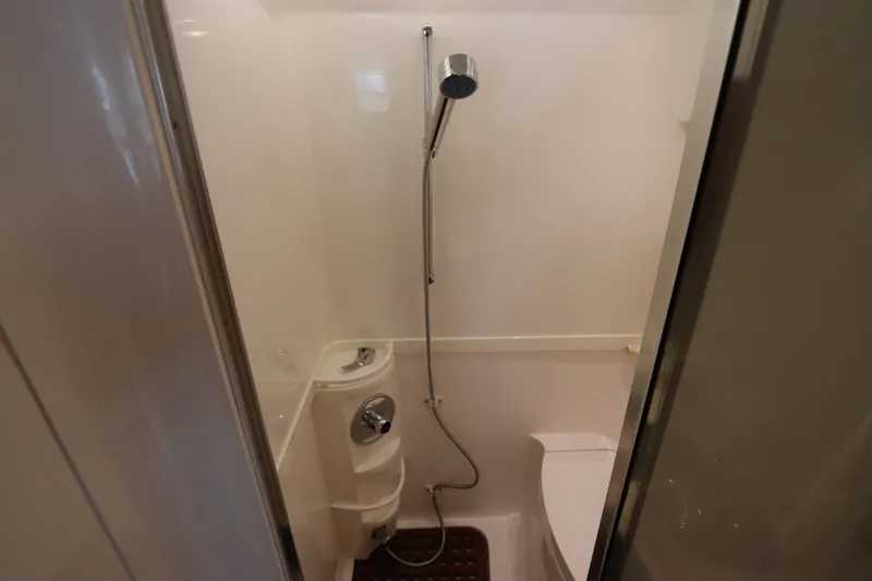 Relentless Yacht Photos Pics Compact bathroom in 2012 Intrepid 430 Sport Yacht with shower and toilet.