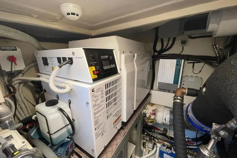  Yacht Photos Pics Engine room of 2017 Ferretti Yachts 550, featuring Cummins Onan generator and various equipment.