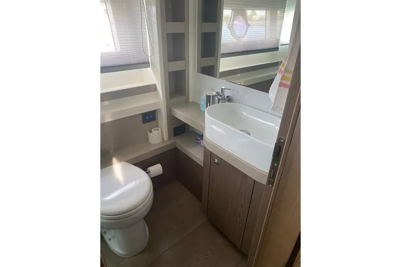  Yacht Photos Pics Bathroom interior of 2017 Ferretti Yachts 550, featuring modern sink and toilet.