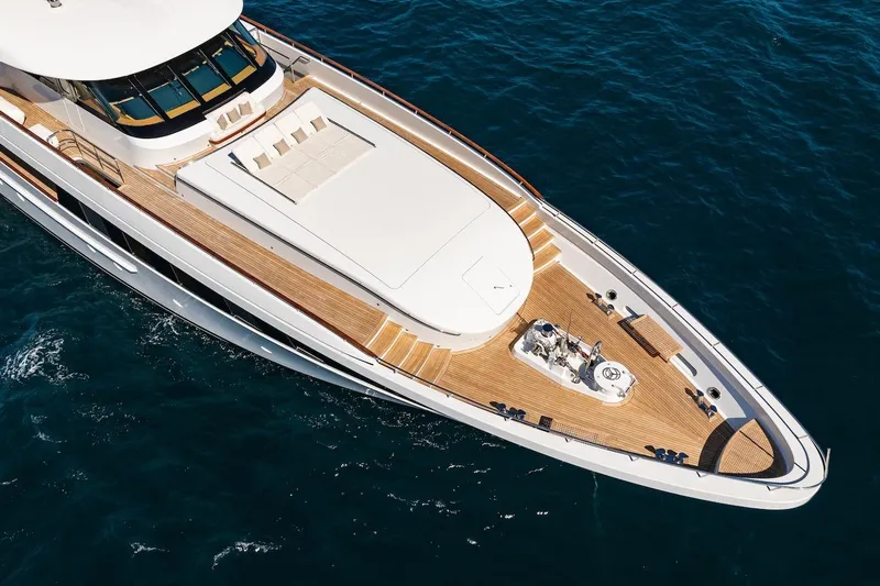 Mystique Yacht Photos Pics Luxurious 2001 Feadship Custom yacht with spacious deck, cruising on clear blue waters.