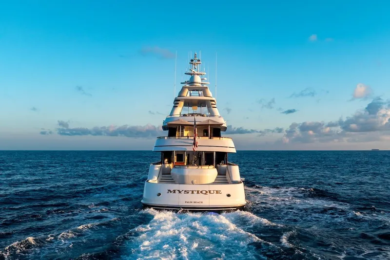 Mystique Yacht Photos Pics Luxurious 2001 Feadship Custom yacht "Mystique" cruising on open sea at sunset.