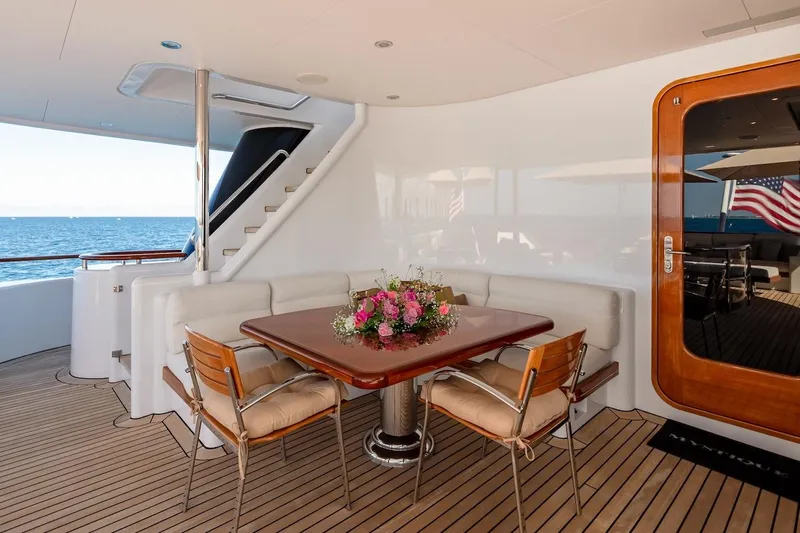 Mystique Yacht Photos Pics Luxurious 2001 Feadship Custom yacht deck with elegant dining area and ocean view.