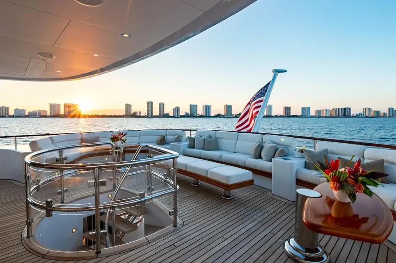 Mystique Yacht Photos Pics Luxurious 2001 Feadship Custom yacht deck with elegant seating, ocean view, and sunset backdrop.