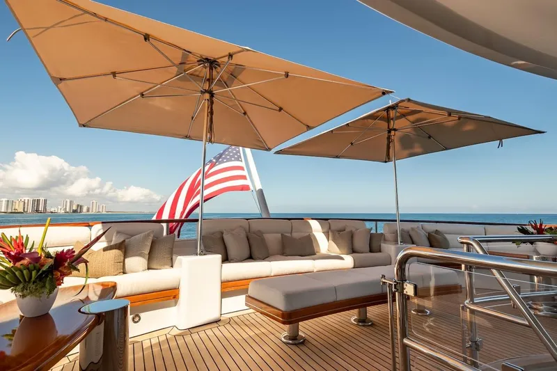 Mystique Yacht Photos Pics Luxurious 2001 Feadship Custom yacht deck with seating, umbrellas, and ocean view.