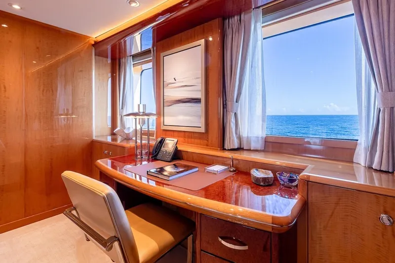 Mystique Yacht Photos Pics Luxurious yacht office interior with ocean view, featuring elegant wood finishes and modern decor.