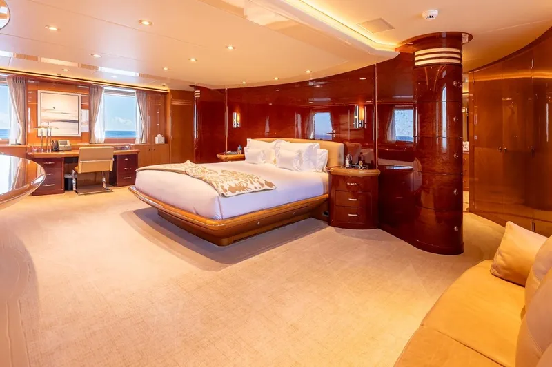 Mystique Yacht Photos Pics Luxurious bedroom interior on 2001 Feadship Custom yacht with elegant wood finishes.