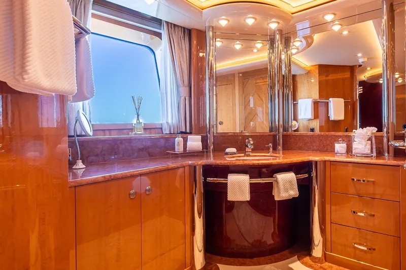Mystique Yacht Photos Pics Luxurious yacht bathroom with wood finishes, elegant lighting, and modern fixtures on a 2001 Feadship Custom.