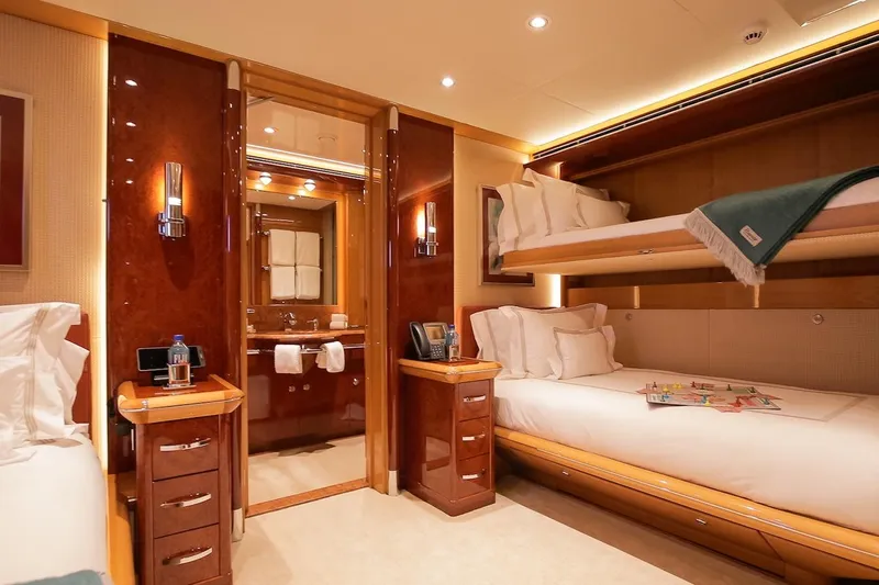 Mystique Yacht Photos Pics Luxurious cabin interior of 2001 Feadship Custom yacht with bunk beds and ensuite bathroom.