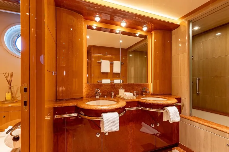 Mystique Yacht Photos Pics Luxurious yacht bathroom with dual sinks, elegant wood finish, and modern lighting, Feadship Custom 2001.
