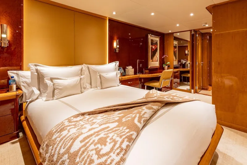 Mystique Yacht Photos Pics Luxurious bedroom interior on 2001 Feadship Custom yacht, featuring elegant decor and plush bedding.