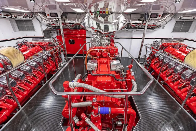 Mystique Yacht Photos Pics Engine room of 2001 Feadship Custom yacht with vibrant red machinery and polished metal surfaces.