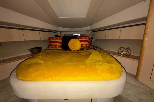 Big Energy Yacht Photos Pics Luxurious cabin interior of 2004 Sea Ray 420 Sedan Bridge with vibrant bedding.