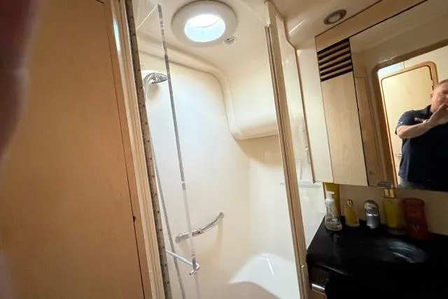 Big Energy Yacht Photos Pics Bathroom interior of 2004 Sea Ray 420 Sedan Bridge yacht, featuring shower and vanity.