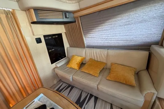 Big Energy Yacht Photos Pics Interior of 2004 Sea Ray 420 Sedan Bridge with beige sofa and yellow cushions.