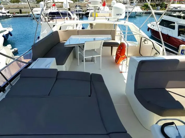  Yacht Photos Pics Luxurious 2013 Prestige 500 yacht deck with seating, table, and marina view.
