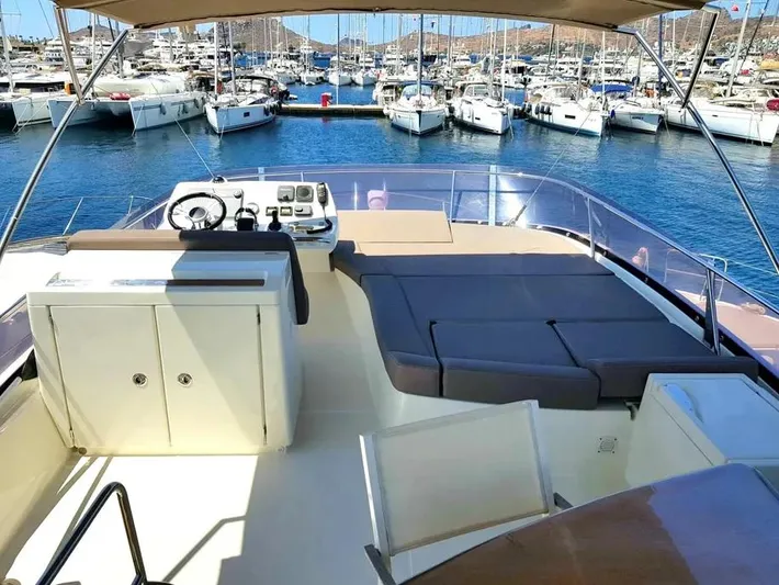  Yacht Photos Pics Flybridge of 2013 Prestige 500 yacht docked in a marina with multiple boats.
