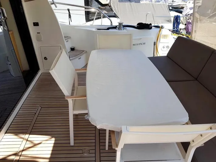  Yacht Photos Pics Outdoor seating area on a 2013 Prestige 500 yacht with table and chairs.