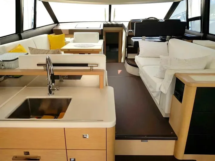  Yacht Photos Pics Luxurious interior of a 2013 Prestige 500 yacht with modern kitchen and seating area.