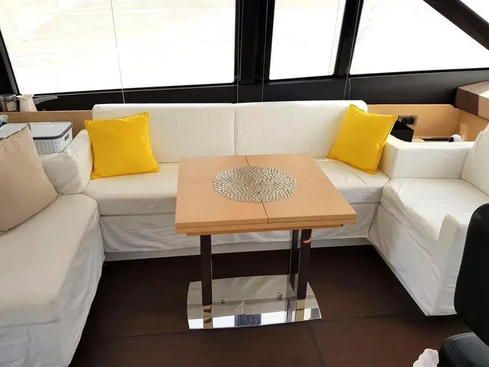  Yacht Photos Pics Luxurious 2013 Prestige 500 yacht interior with white seating and yellow cushions.