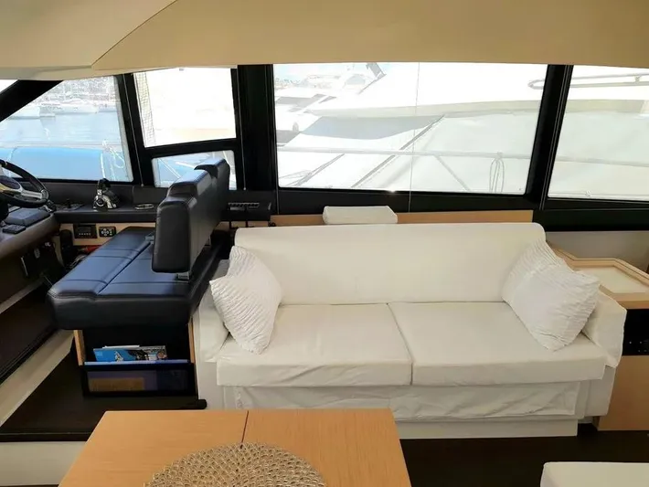  Yacht Photos Pics Luxurious interior of a 2013 Prestige 500 yacht with white sofa and helm station.