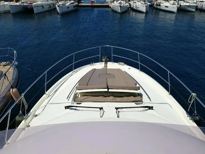  Yacht Photos Pics 2013 Prestige 500 yacht docked in a marina, surrounded by other boats.