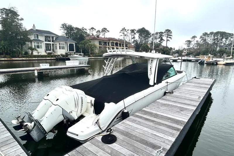  Yacht Photos Pics 2017 Boston Whaler 320 Vantage docked at a marina, covered and ready for use.