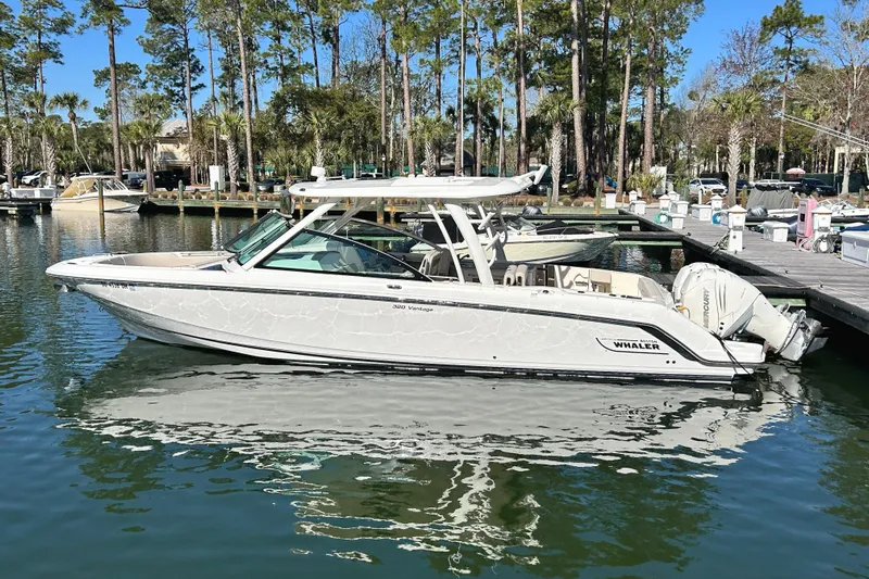  Yacht Photos Pics 2017 Boston Whaler 320 Vantage boat docked in a serene marina setting.